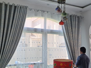Grey curtains and sheers on a villa bay window fitted by StyFect in Dubai, UAE